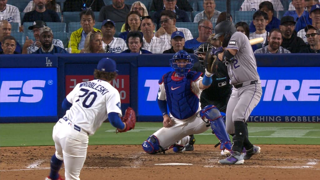 A major league stadium video board showing a replay review sequence as players wait on the field during a Los Angeles Dodgers game
