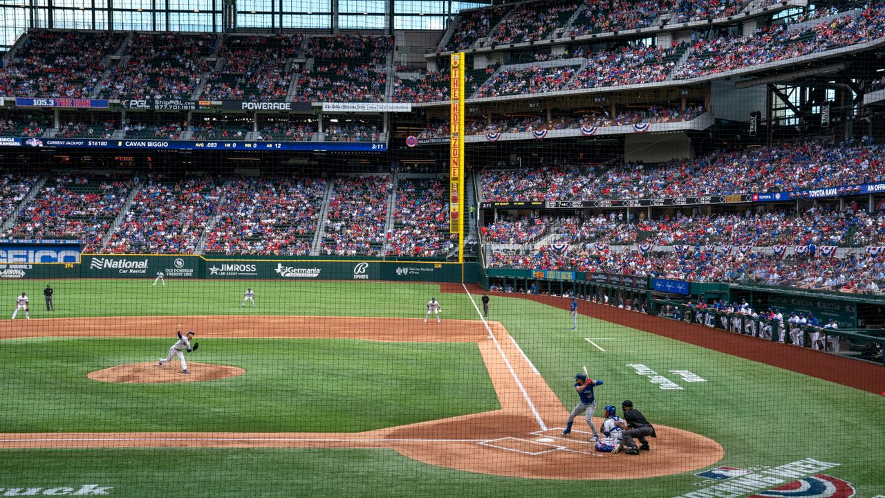 A wide view of a baseball stadium crowd, illustrating the article’s ‘crowd noise’ metaphor for options positioning and investor anxiety.