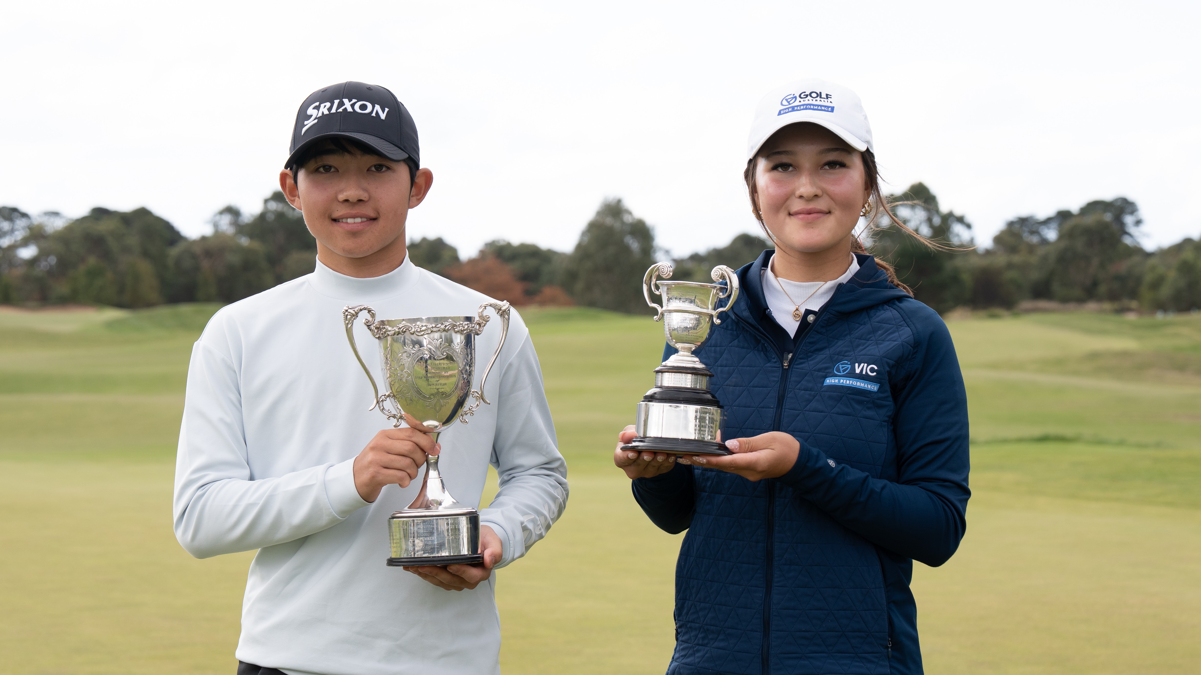 A young golfer stands on a tee box preparing to hit a drive during a junior tournament