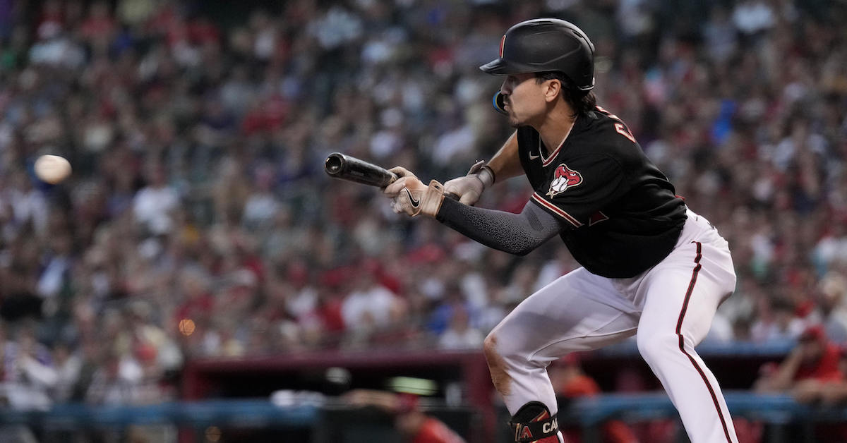 An MLB pitcher squaring to bunt with runners on base while the corner infielders charge in during live game action