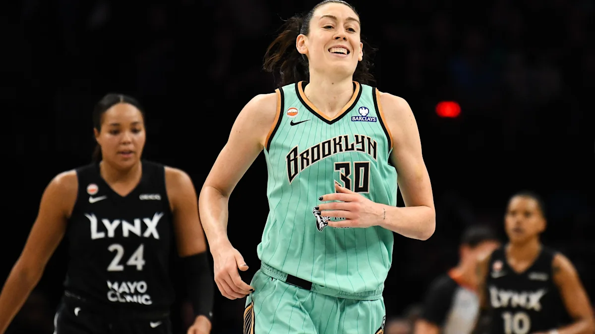 Breanna Stewart handling the ball in a WNBA playoff game as defenders close in