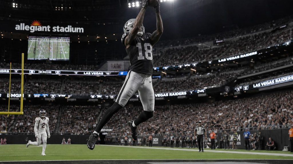 Jack Bech catching a touchdown pass in the end zone in a Raiders preseason game, securing the ball with both hands while a defender trails behind