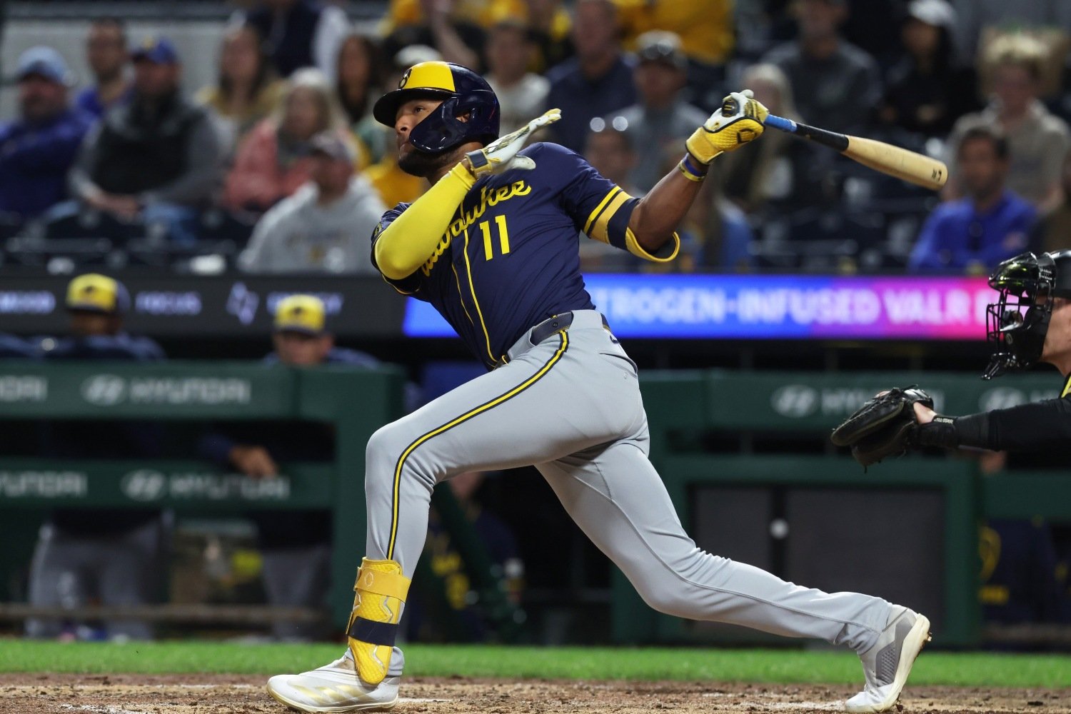Jackson Chourio in a Milwaukee Brewers uniform finishing a right-handed swing, watching the ball travel toward the outfield