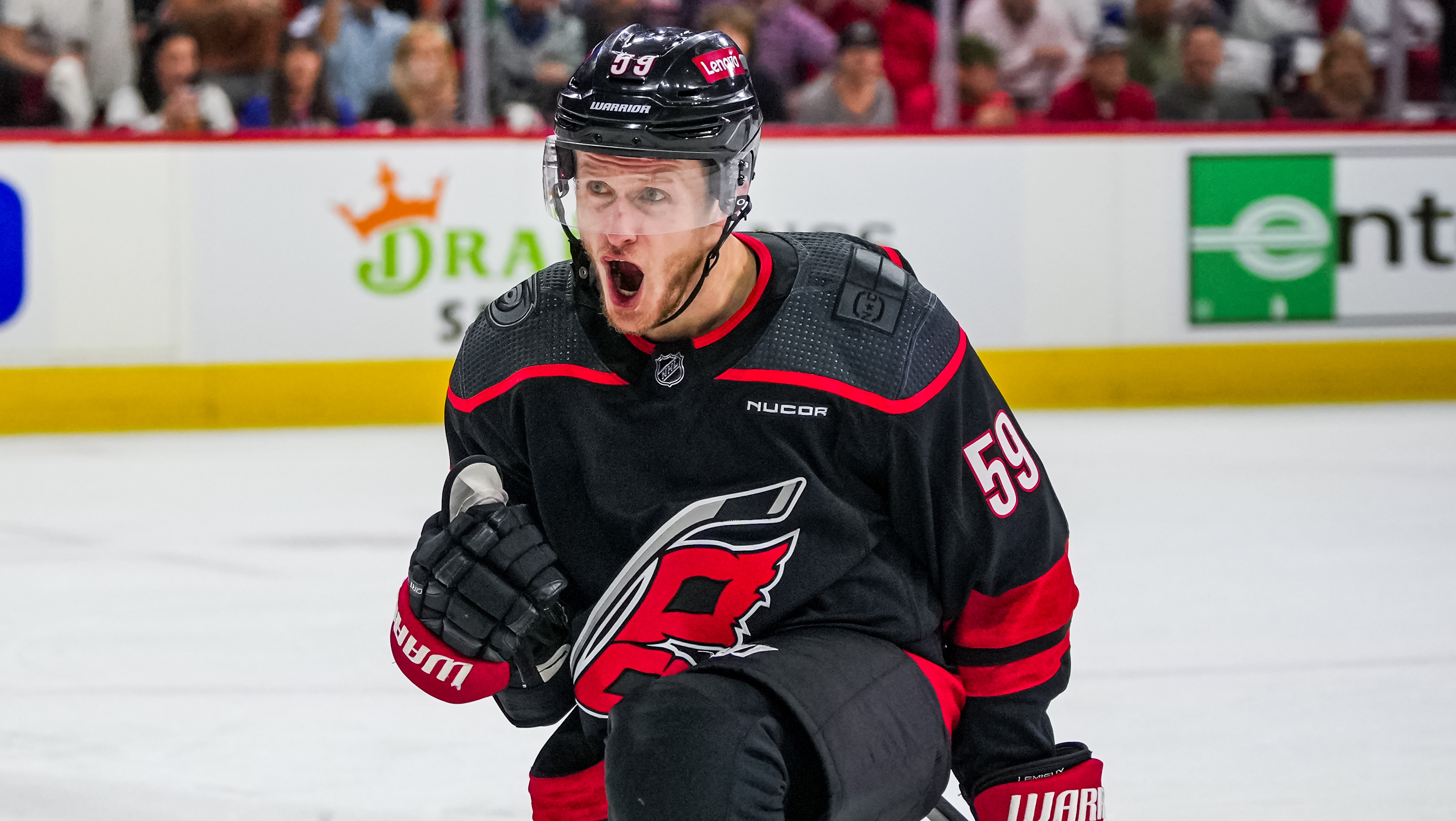 Jake Guentzel in a Carolina Hurricanes jersey skating with the puck during an NHL game