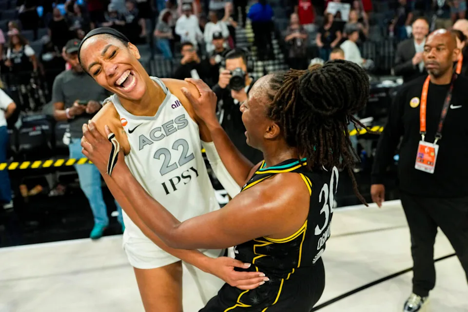 Las Vegas Aces center A'ja Wilson posting up near the paint during a WNBA playoff game while defenders collapse around her