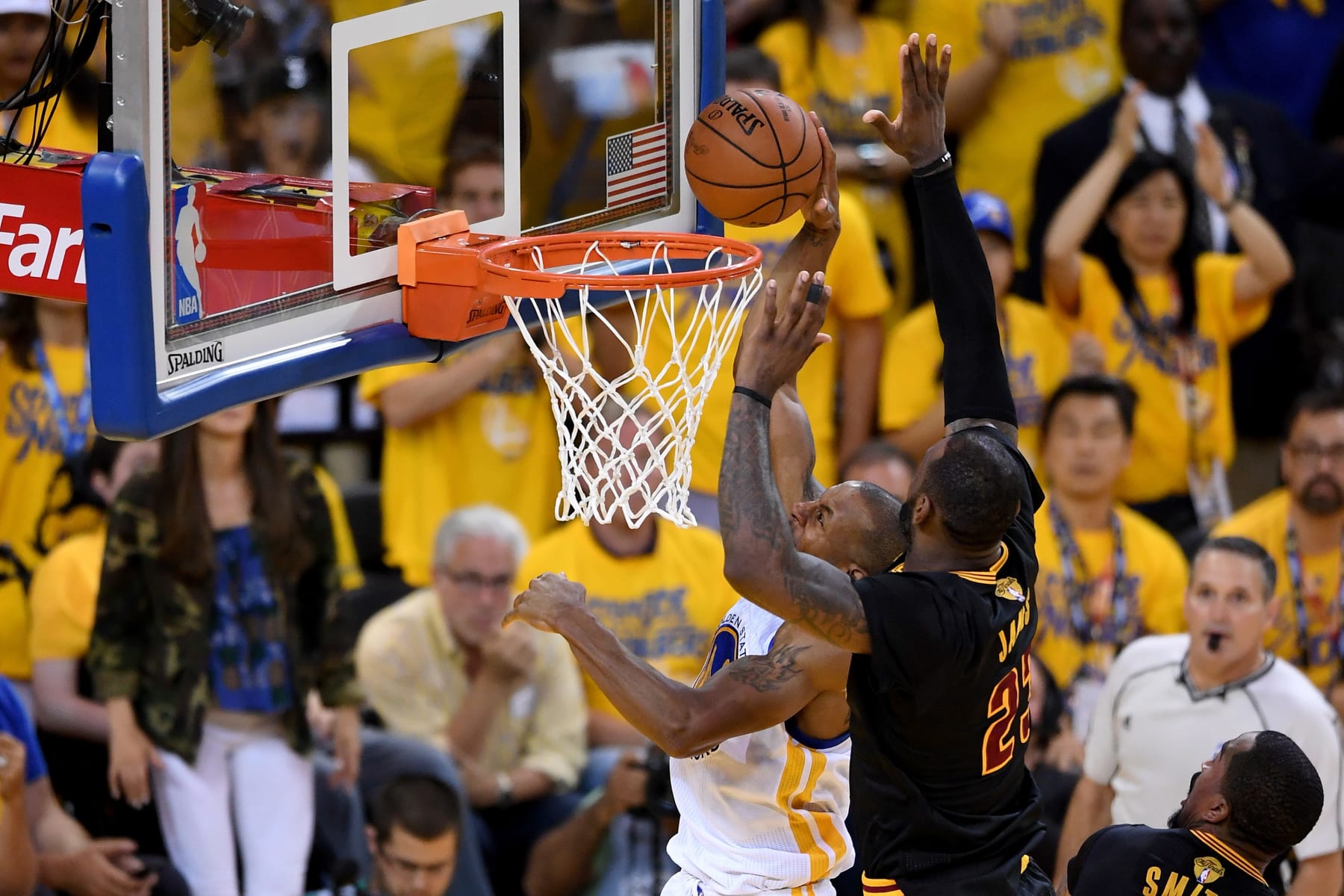 LeBron James elevating to block a fast-break layup in Game 7 of the 2016 NBA Finals with the crowd standing behind the play
