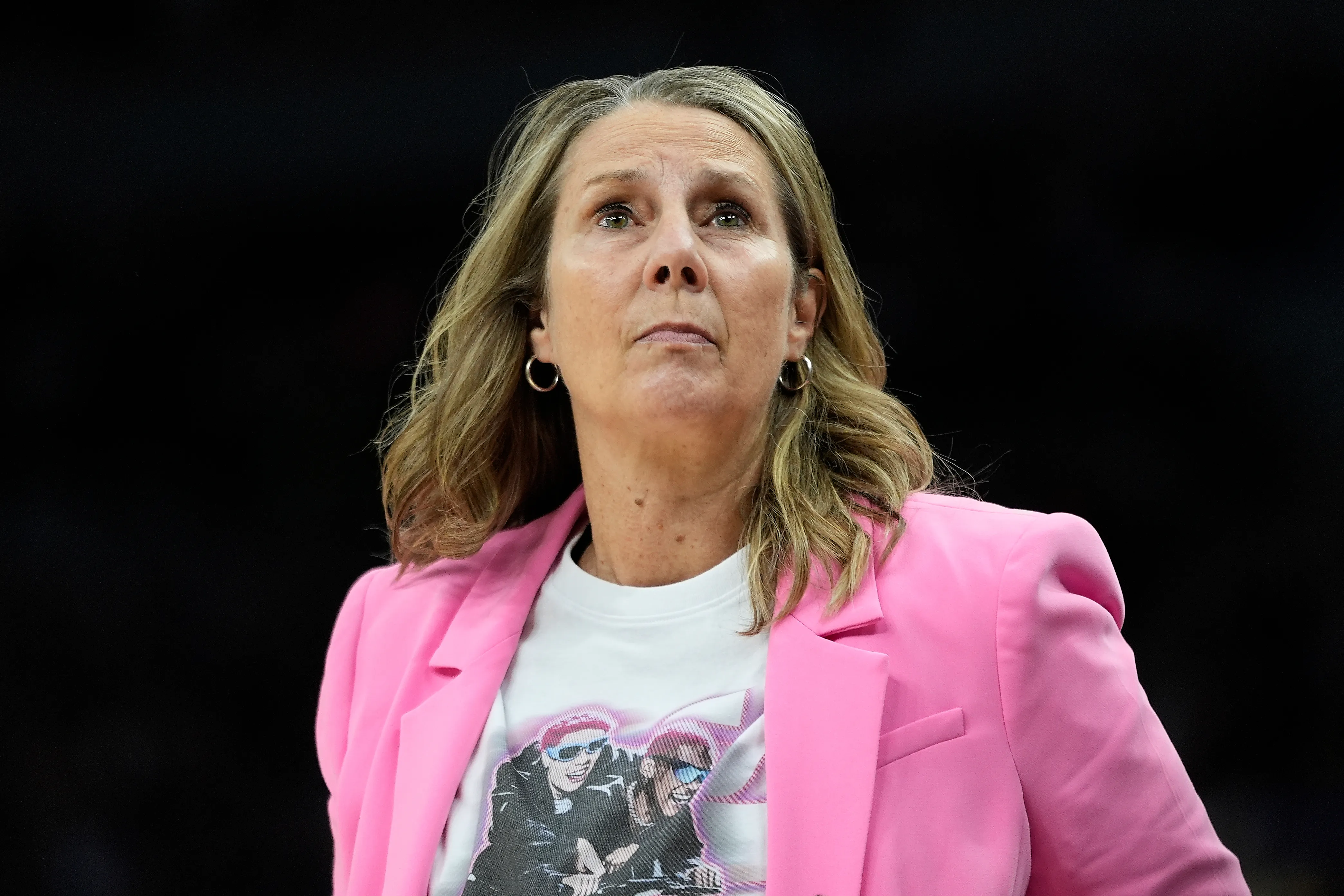 Minnesota Lynx head coach Cheryl Reeve standing near the sideline during a WNBA playoff game, watching the action