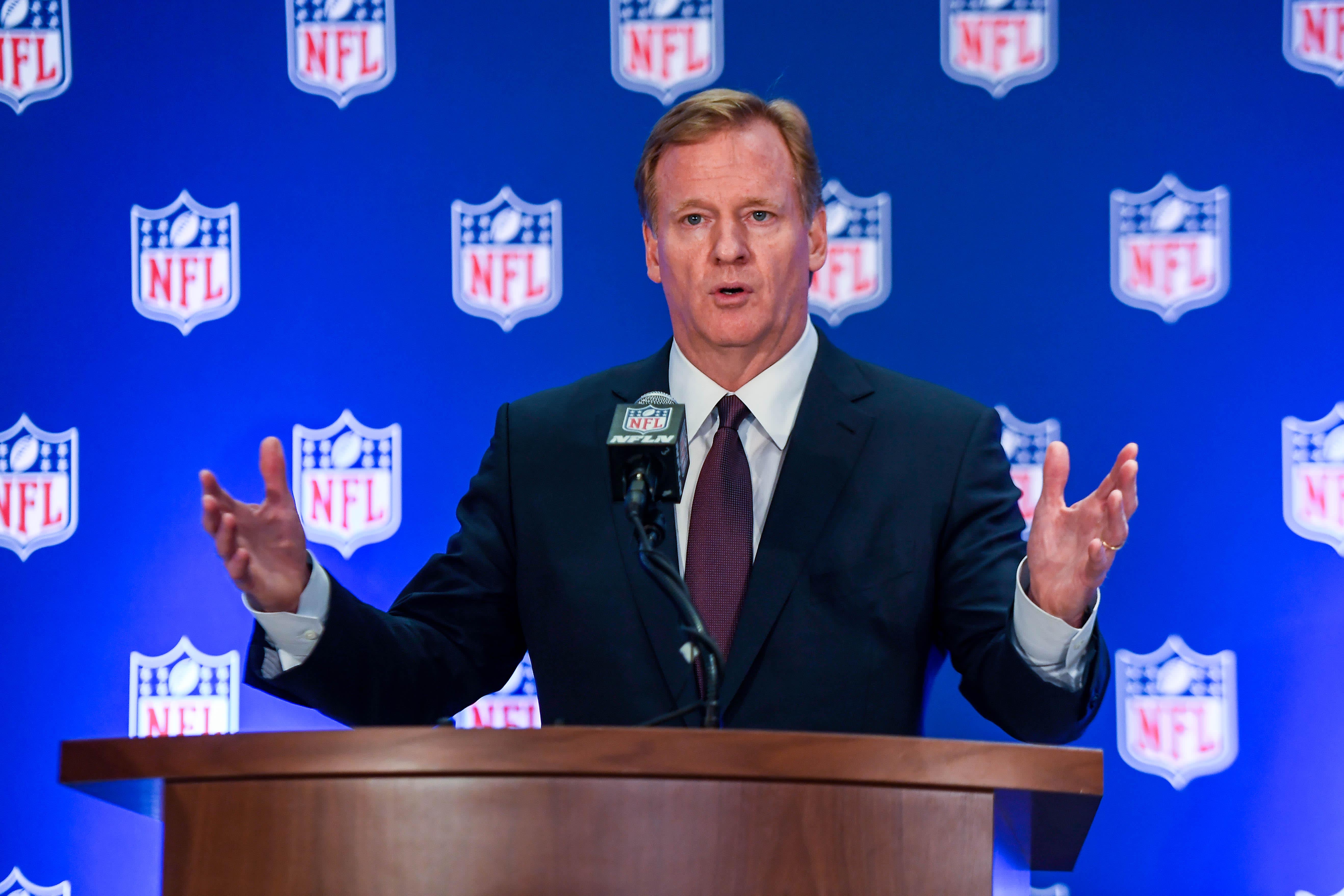 NFL commissioner Roger Goodell speaking at a press conference podium