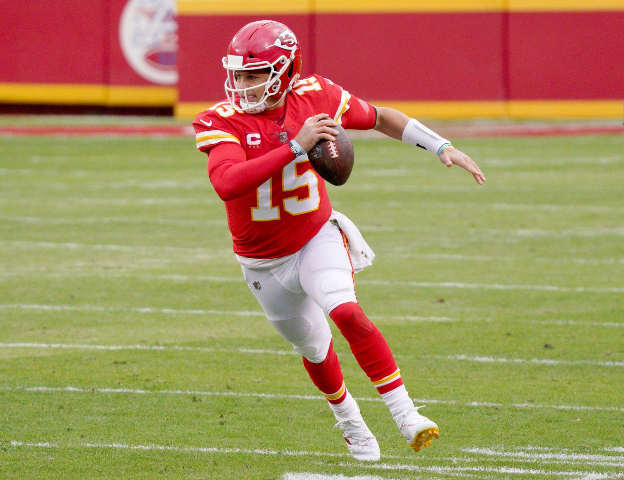 Patrick Mahomes in a pocket dropback during an NFL game, linemen engaged at the line of scrimmage as the play develops