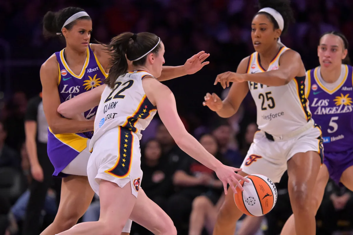 Rae Burrell in a Los Angeles Sparks uniform driving to the basket against the Indiana Fever with defenders closing, game action photograph