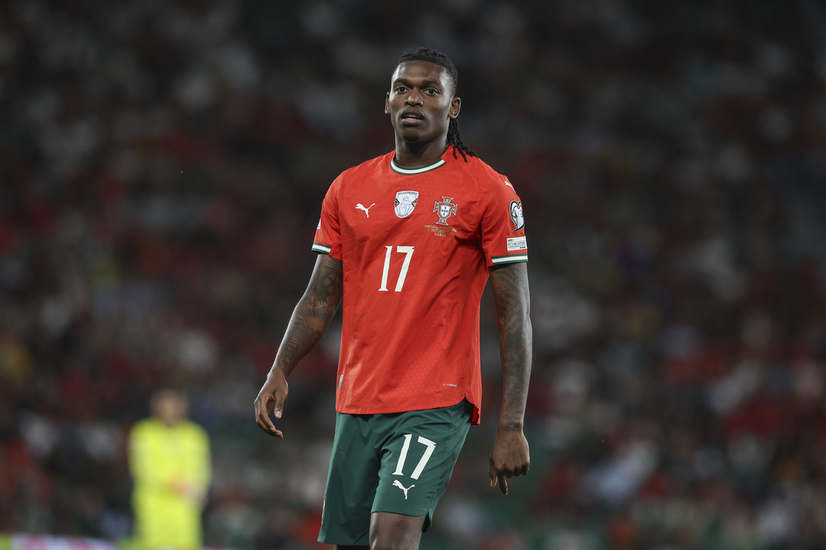 Rafael Leão in a Portugal kit driving forward down the left with the ball as defenders retreat