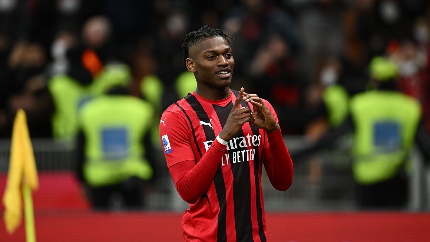 Rafael Leão in an AC Milan kit carrying the ball down the flank during a Serie A match