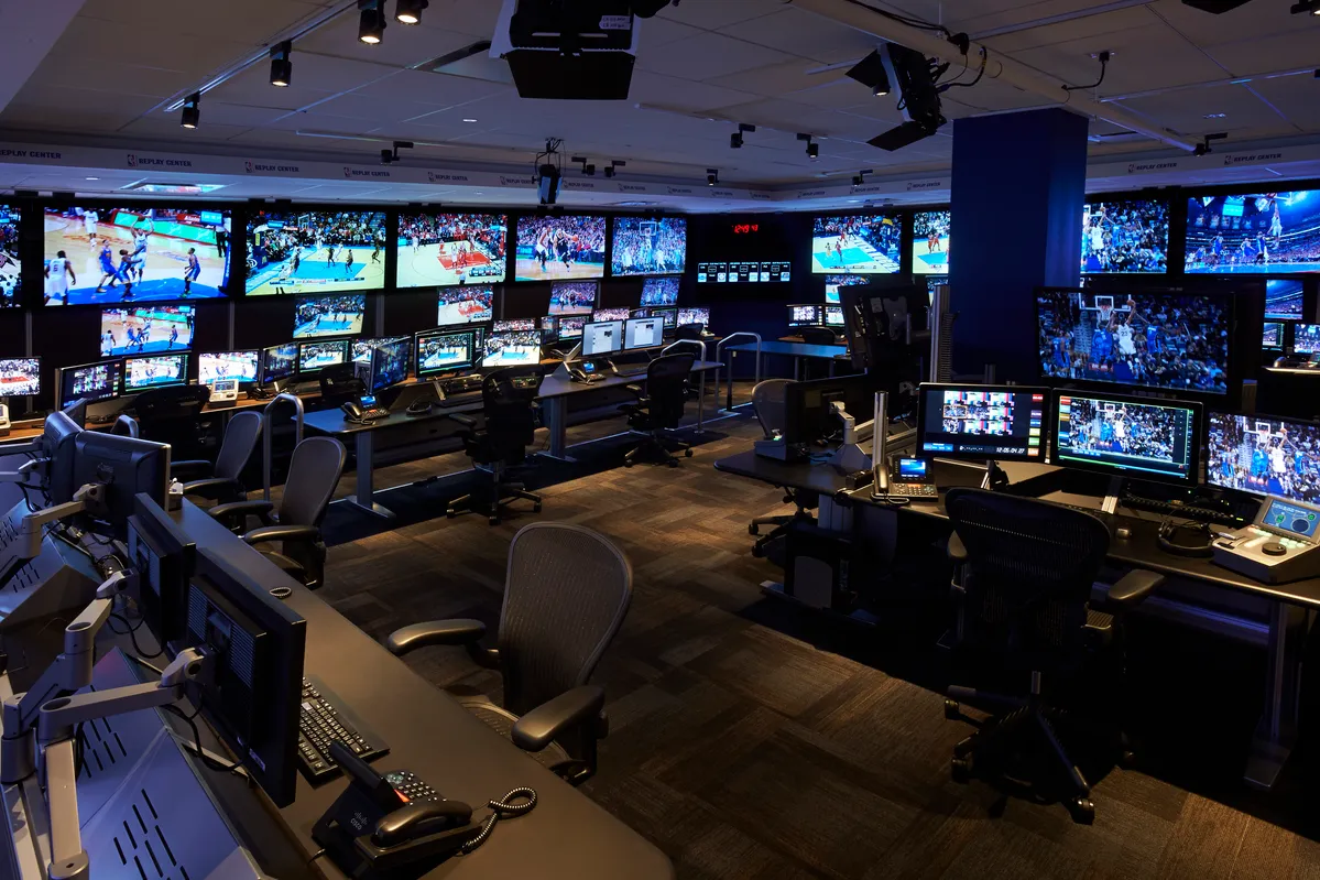 Staff working inside the NBA Replay Center, monitoring multiple game angles to assist officials with review decisions