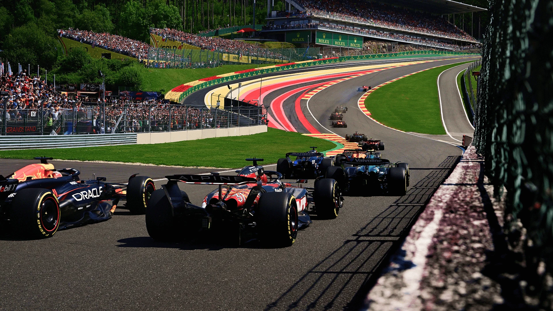 The Formula 1 field launches off the grid at Spa-Francorchamps and funnels toward the opening corners