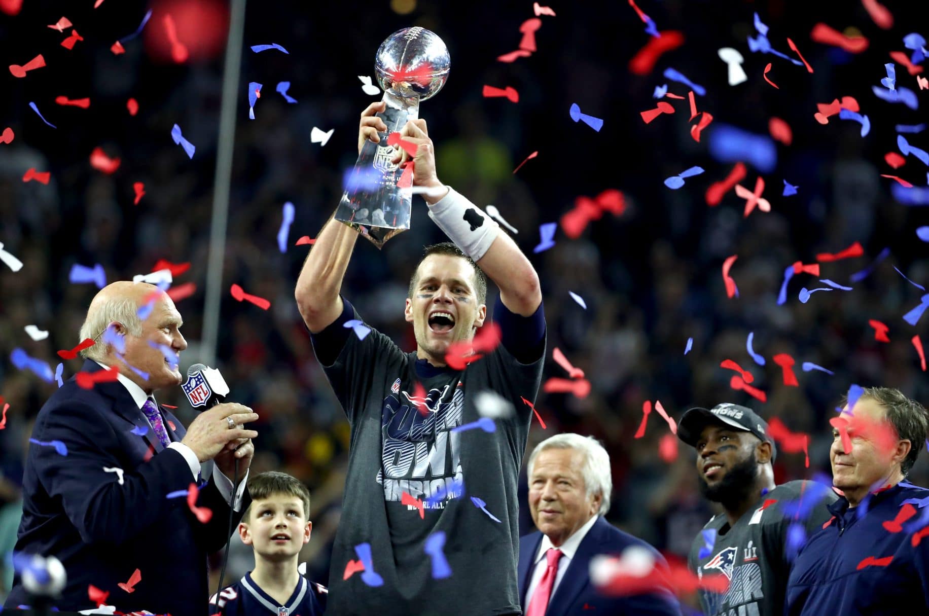 Tom Brady on the field during Super Bowl LI with teammates celebrating during the comeback against the Atlanta Falcons