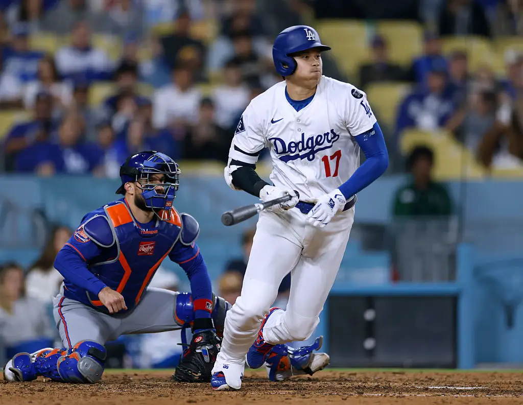 Wide in-game view of a Los Angeles Dodgers vs New York Mets matchup with the pitcher on the mound and a packed stadium behind home plate